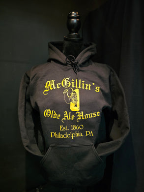 A black hoodie with 'McGillin's Olde Ale House' text and the bell in hand logo in yellow on the front.