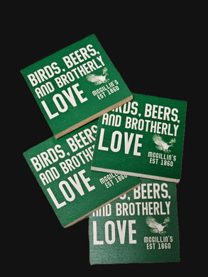 Green coasters with text and a logo on a black background