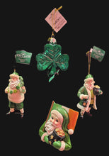 Set of four festive ornaments including a Santa Claus and a shamrock.