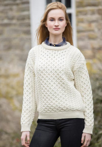 Woman wearing a white textured sweater 