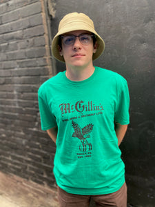 green T-shirt with text and a bird illustration
